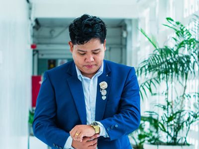 Active businessman looking at watch representing time management
