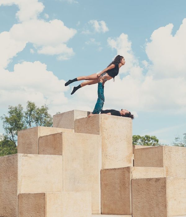 Man performing physical balance exercises in a modern space